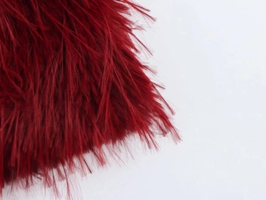 Close-up detail of dark red faux fur and shimmering sequins on a winter dress
