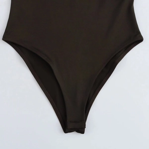 Detailed view of the crotch area and precision stitching of the slim fit bodysuit
