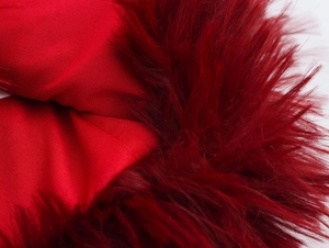 Detail of red faux fur and matching plain fabric texture on the sequin dress sleeve