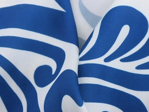 Detailed macro view of the silky blue and white abstract print fabric with satin finish