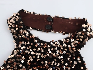 Detail view of back closure with two buttons on sequined halter neck dress