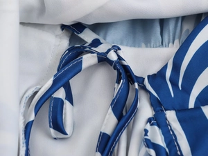 Detailed macro view of the blue and white striped fabric with a drawstring tie design