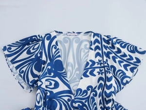 Close-up of V-neckline and baroque scroll print on summer floral maxi dress