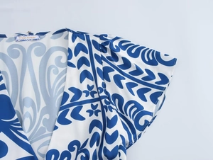 Detail of the V-neck and ruffled sleeves on this blue floral print summer dress
