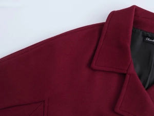 Close-up of wine red wool blend coat with notched lapel and fine stitching details