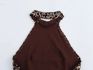 Close-up of sequined halter neckline on dark brown backless dress with metallic details