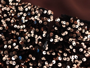 Close-up of invisible zipper and shimmering sequins on the back of a backless dress