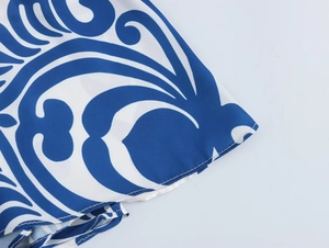 Detailed macro view of the blue and white floral print on lightweight woven fabric dress