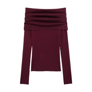 Detail of off-shoulder wine red ribbed knit top showing texture and folded collar design