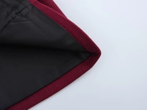 Detailed macro view of the wine red wool fabric and smooth black inner lining texture