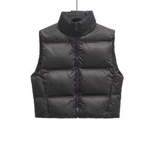 Detail of black stand-collar quilted puffer vest with zipper closure and matte finish