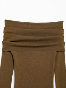 Detail of the layered ruffles and textured knit on a tan off-shoulder sweater