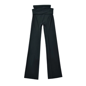 Close-up detail of high-waisted black flared yoga trousers with elastic fold-over waistband