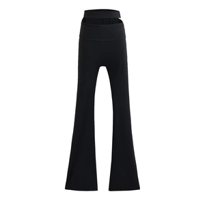 Detail showing high-waist cutout design and slim fit flared silhouette on black trousers