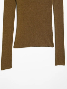 Detailed view of dark brown knitted long sleeve top with fine flat stitch texture and hem