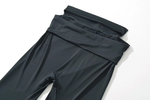Close-up of high-waist foldover design on slim fit black yoga pants for women
