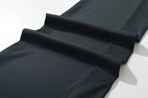 Detailed view of high-elastic black fabric texture with fine twill weave structure