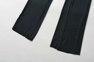 Detail shot of the hem of black wide-leg trousers featuring premium high-stretch fabric