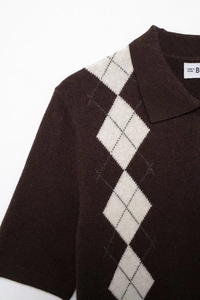 Detailed view of dark brown knit polo shirt featuring classic argyle diamond pattern