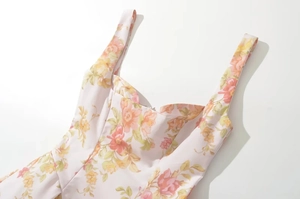 Close-up of heart-shaped neckline and floral print pattern on slim mini sun dress