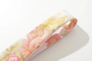 Detail shot of the floral print fabric and fine stitching on a slim-fit summer mini dress