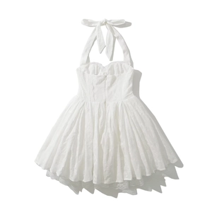 Detail of white halter mini dress featuring intricate floral embroidery and lace trim edges