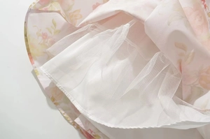 Detail of floral print fabric with layered white tulle lining for a voluminous skirt hem