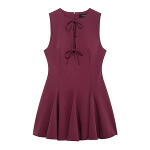 Sleeveless burgundy A-line dress featuring pleated skirt and bow tie-up neckline