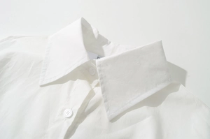 Close-up of classic pointed collar and white buttons on a crisp cotton shirt