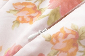 Detailed macro view of high-quality invisible zipper on a floral print mini dress