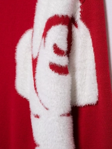 Detail of red knit sweater featuring plush white faux fur contrast and fine texture
