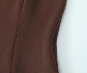 Macro shot of dark brown twill fabric texture showing high-quality weaving detail