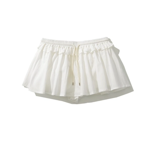 Detail of white A-line skirt featuring elastic waistband and adjustable drawstring tassels