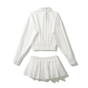 Detailed flat lay of white two-piece set featuring cropped shirt and ruffled mini skirt