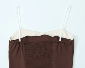 Detail of elastic smocking back and thin straps on the brown contrast camisole top