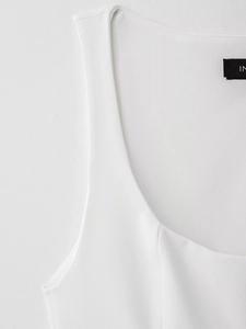 Gros plan du haut sans manches blanc avec col en U et texture de maille haute densité