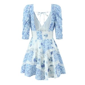 Back view of blue floral V-neck dress with lace waist and open back tie design