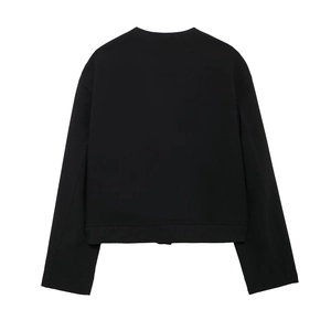 Detailed view of the black oversized jacket showing rib-knit hem and high-quality fabric