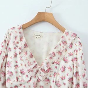 Floral V-neck long sleeve blouse with ruffle edges and delicate buttons on white chiffon