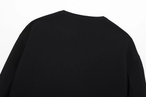 Detail of the high-quality stitching on the neckline of a black crewneck jacket