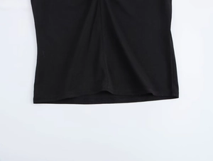 Detailed close-up of the black off-shoulder top showing seamless hemline and fabric texture