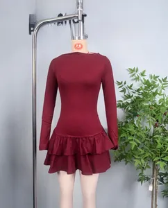 Detail of the pleated double ruffle hem on a burgundy long sleeve knit dress