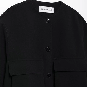 Women's black minimalist casual jacket with pocket detail and round neck style