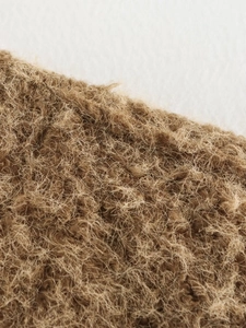 Gros plan macro sur un tissu en laine de chameau haut de gamme avec texture bouclée