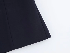 Detail of navy twill fabric showing fine stitching and clean hem finish on halter top