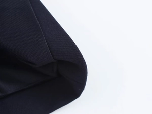 Close-up of black twill woven fabric showing detailed texture and high-quality stitching