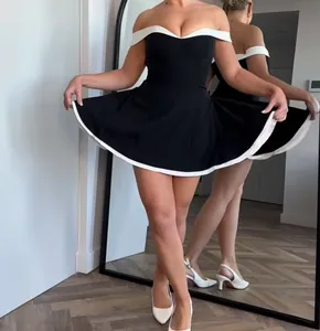 Detailed close-up of the black and white off-the-shoulder dress with A-line skirt