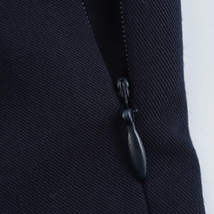 Detailed close-up of high-quality invisible zipper on navy twill slim fit dress