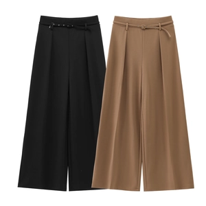 Detailed view of high-waisted wide-leg trousers in black and camel with belts
