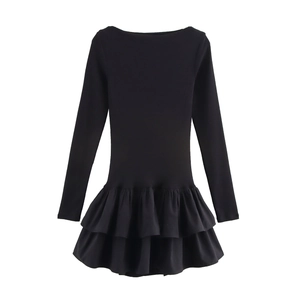 Detail of double-layered ruffle hem on a black long sleeve slim-fit mini dress